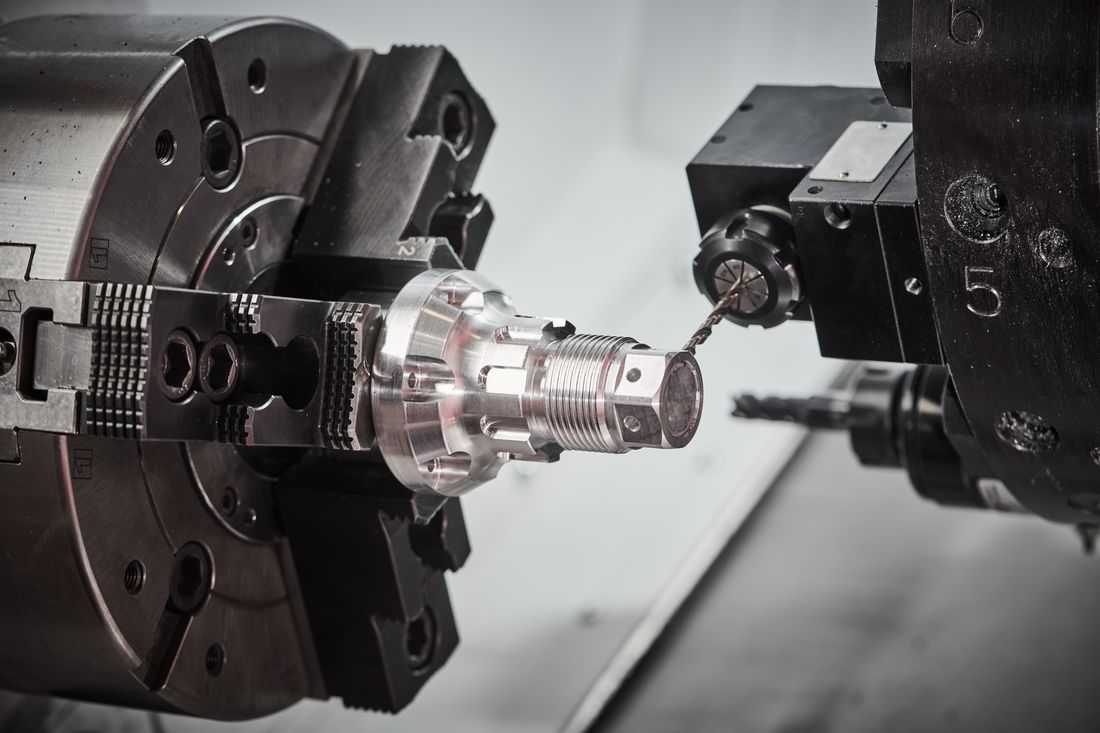 CNC lathe turning a precision aluminum prototype part